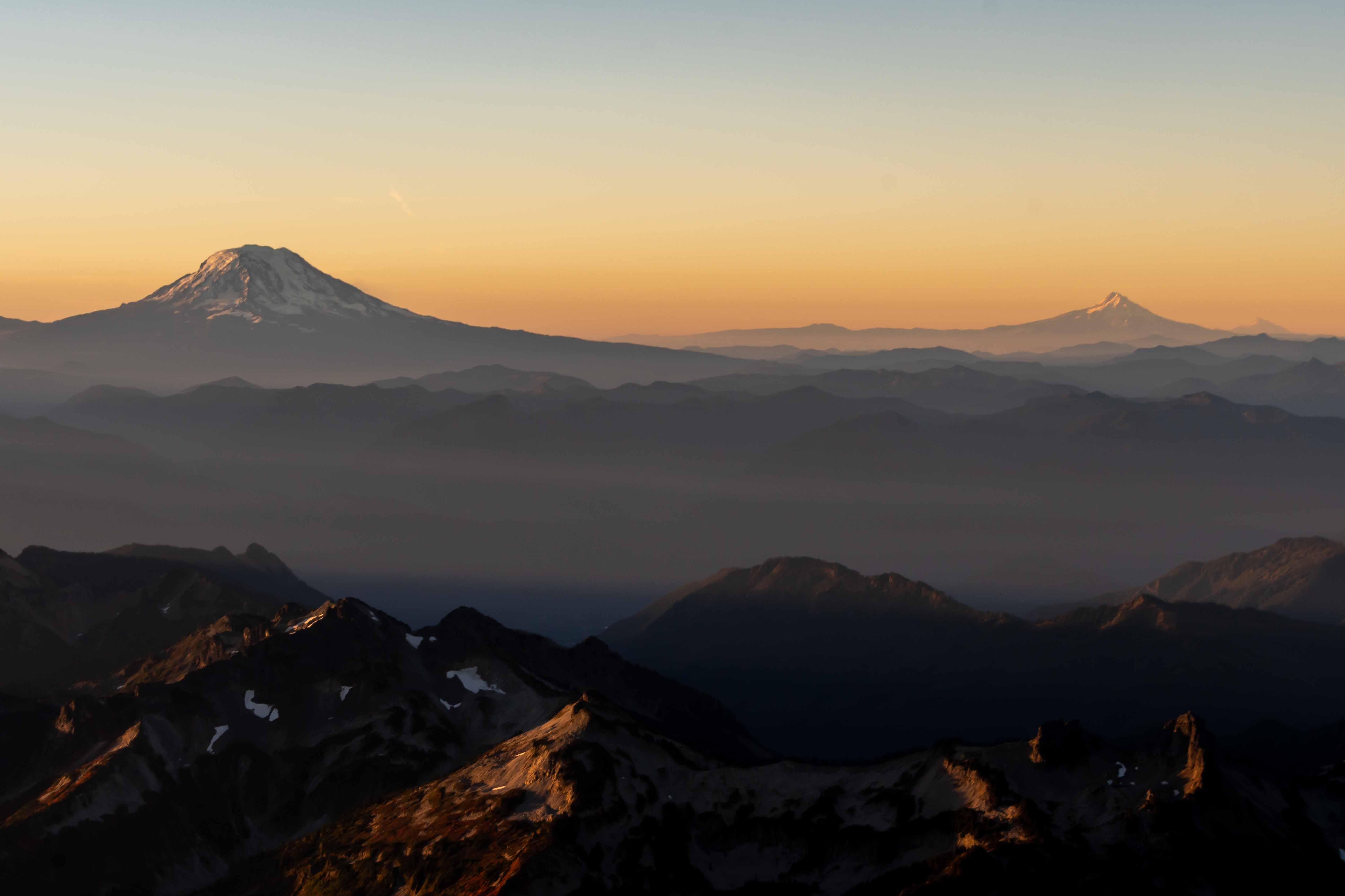 Mt. Rainier at sunset with smaller Cascade peaks in the distance, Washington